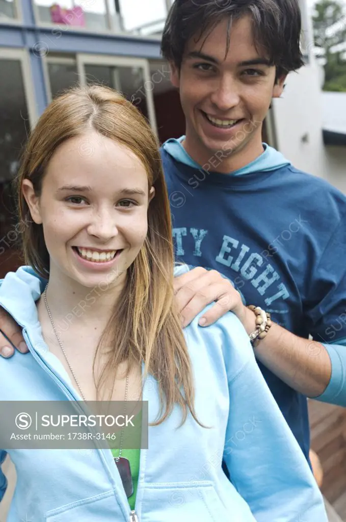 Teenage boy and girl smiling for the camera