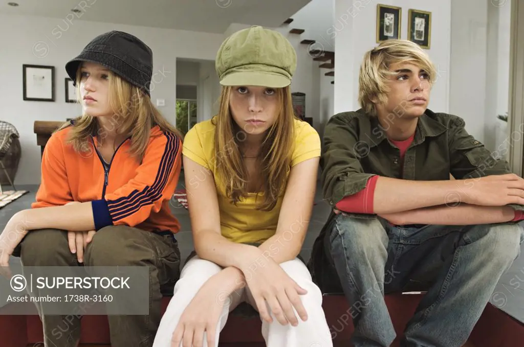 2 teenage girls and 1 teenage boy looking sullen