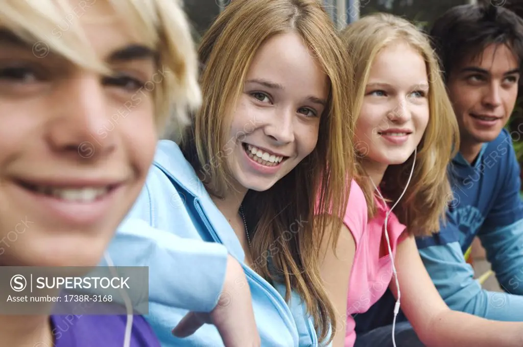 2 teenage boys and 2 teenage girls smiling for camera