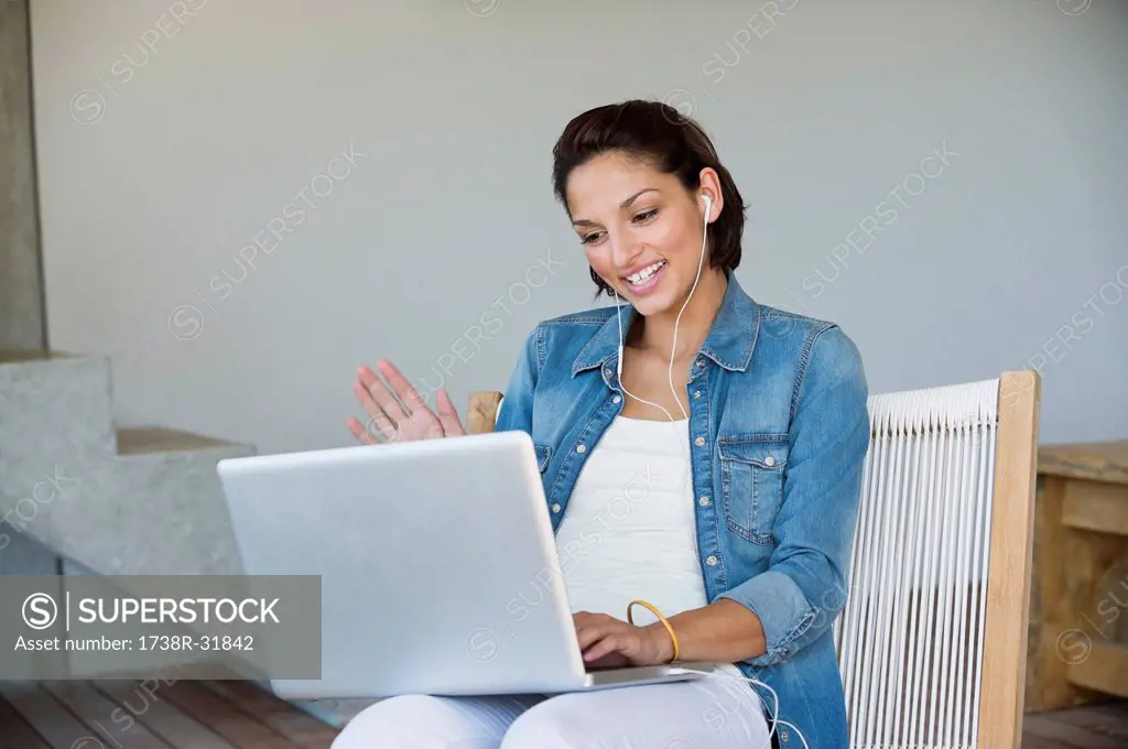 Woman doing online chatting on a laptop