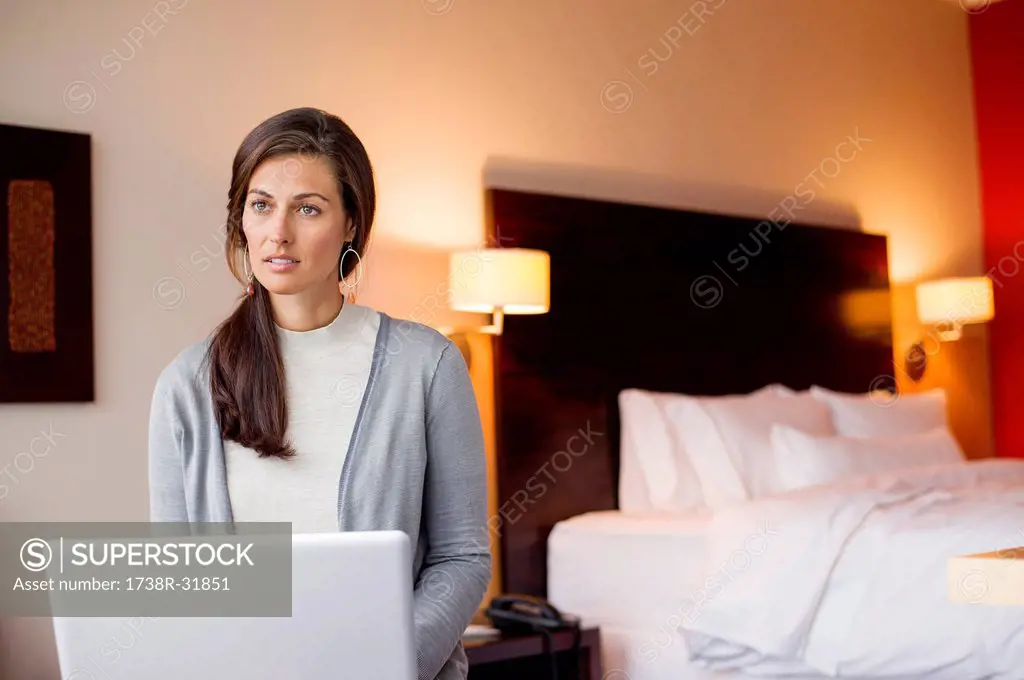 Woman using a laptop in a hotel room