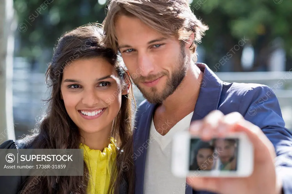 Couple taking picture of themselves with a mobile phone