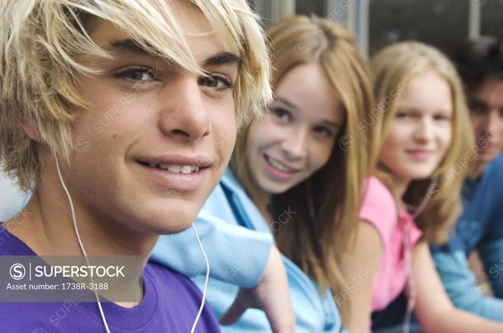 2 teenage boys and 2 teenage girls smiling for camera