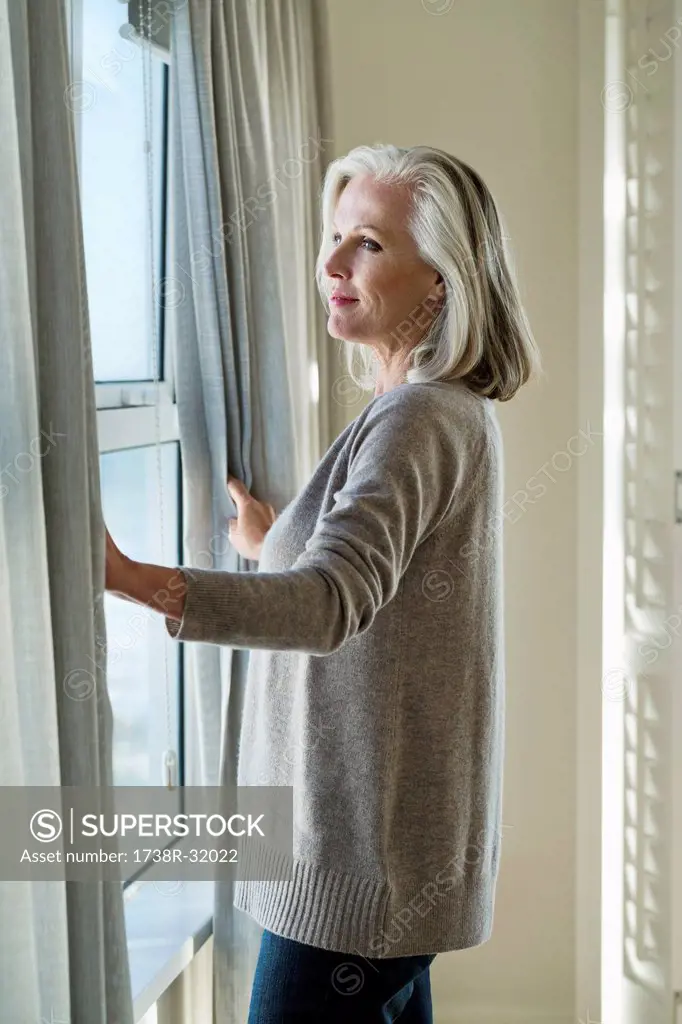 Woman standing by a window