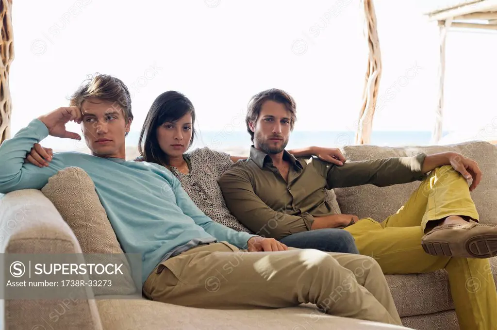 Three friends sitting together on a couch