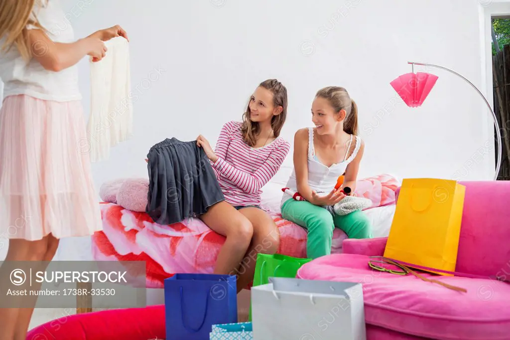 Girl showing skirt to her friends at a slumber party