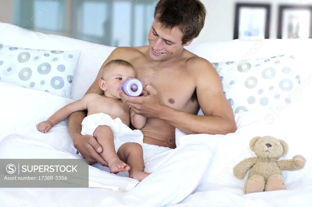 Father feeding his baby, indoors