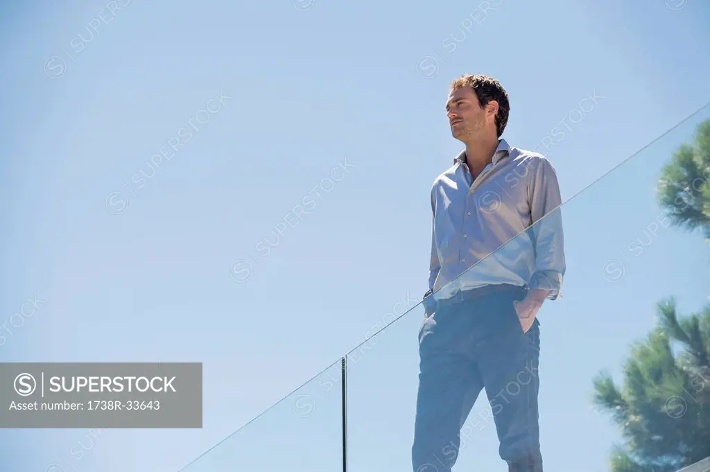 Man standing on the terrace with his hands in his pockets