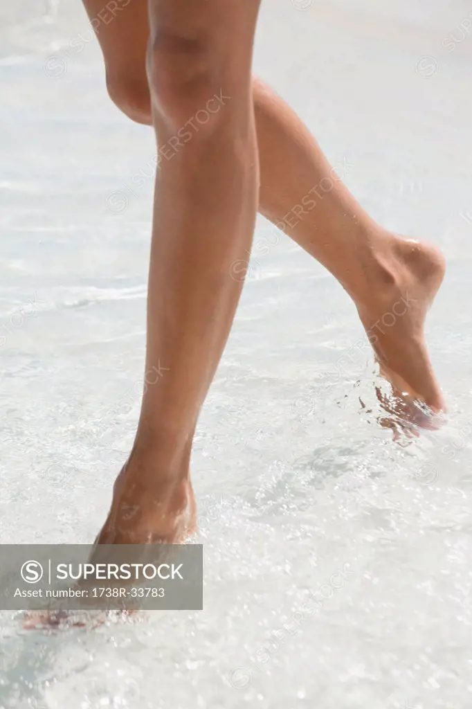 Woman walking in water on the beach