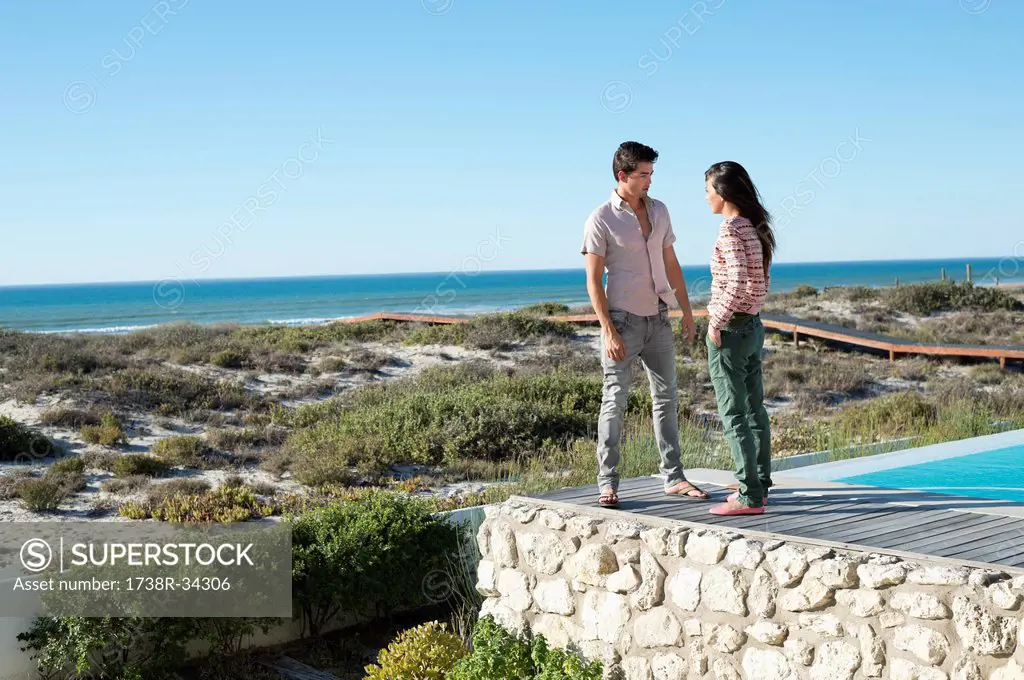 Couple standing on a boardwalk on the beach