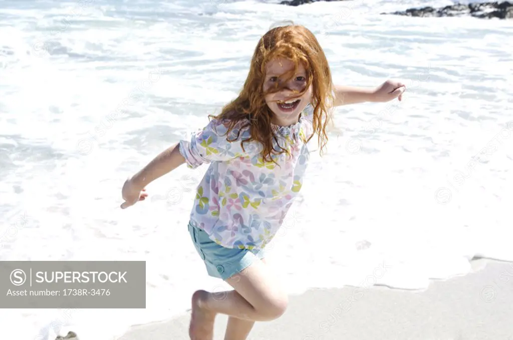 Little girl walking on the beach, outdoors