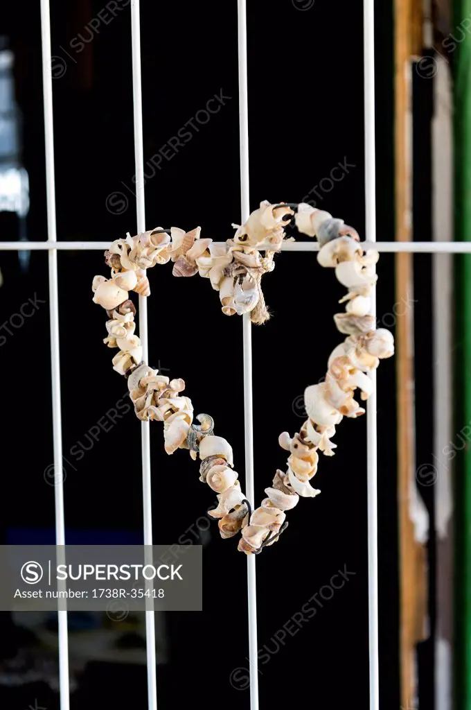 Heart shape made from sea shells hanging on a window