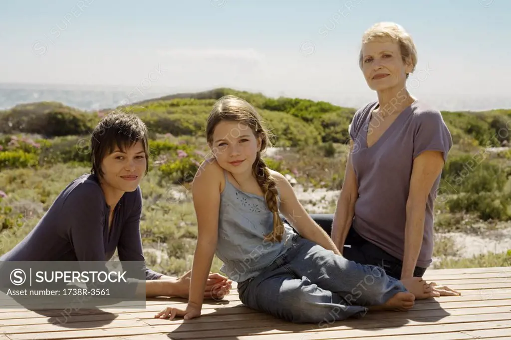 Female members of three generation family looking at camera, outdoors