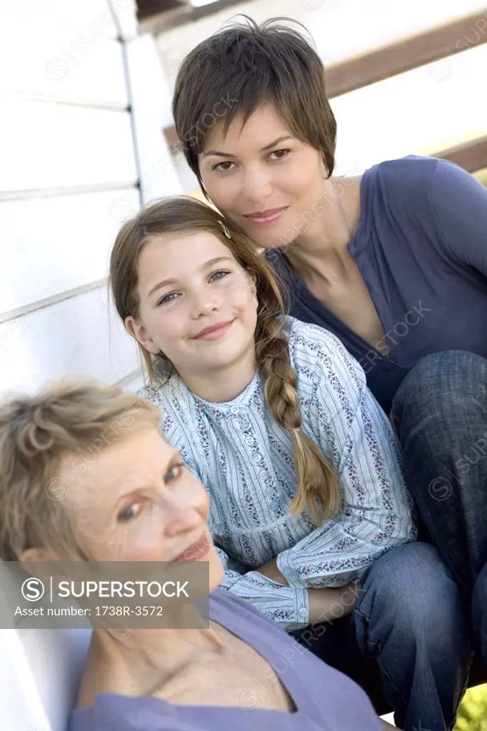 Female members of three generation family looking at camera, outdoors