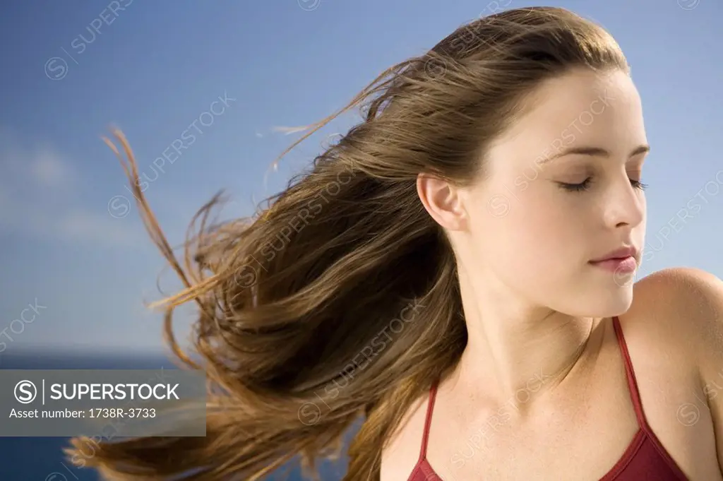 Portrait of a young woman, shut eyes, outdoors