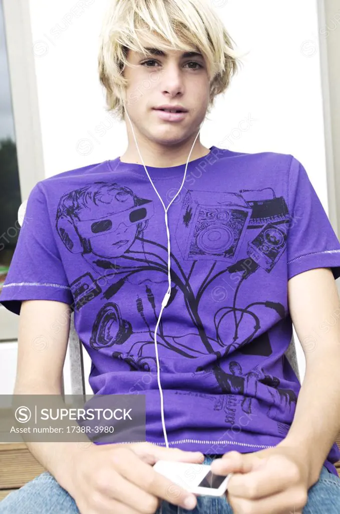 Teen boy listening to MP3 player