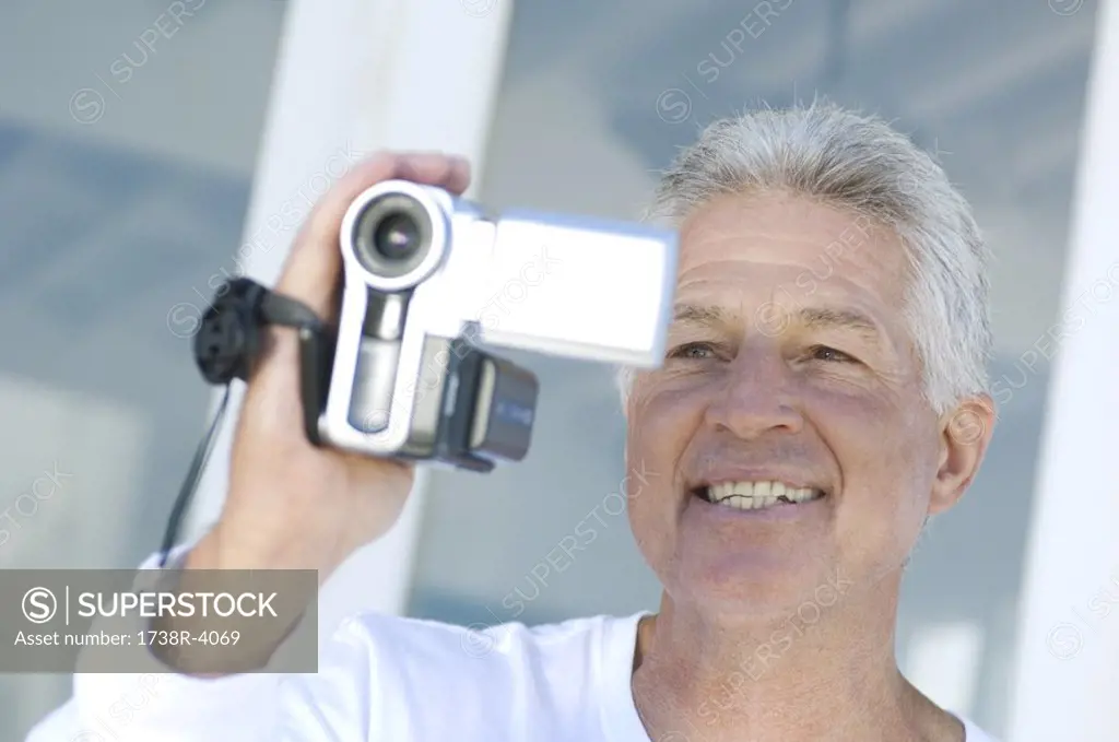 Portrait of a man using camcorder