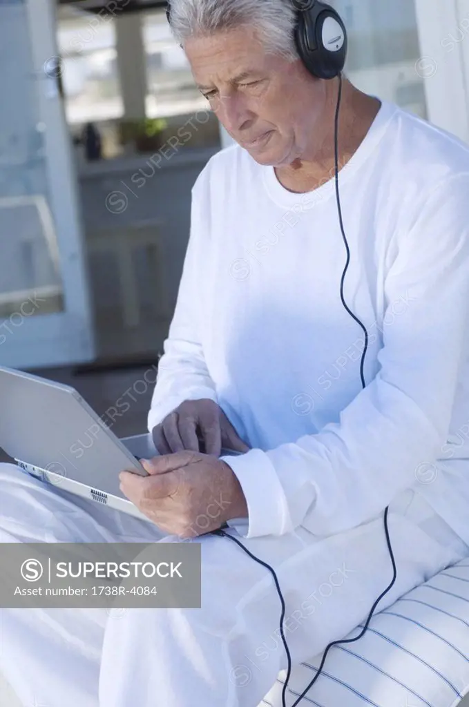 Man with headphones using laptop