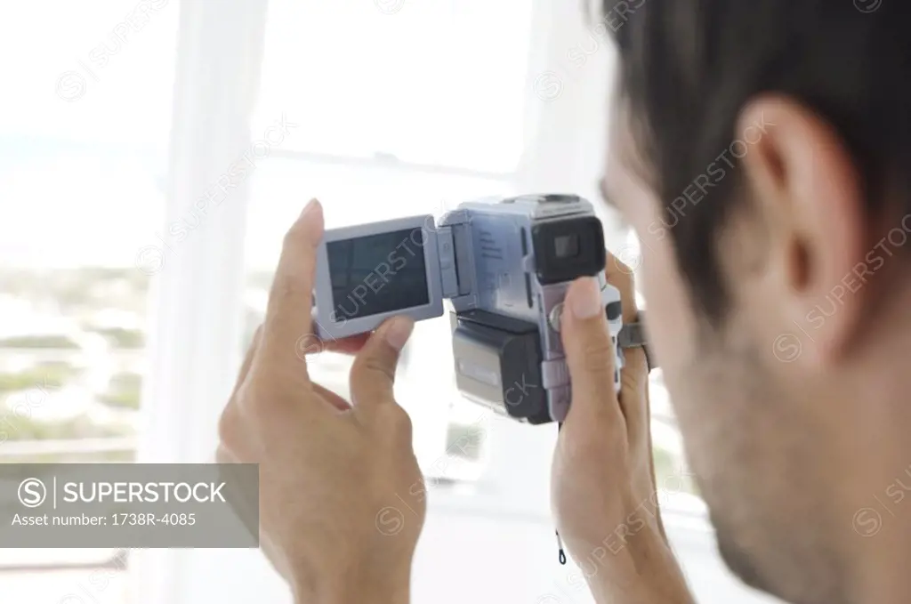 Young man using camcorder