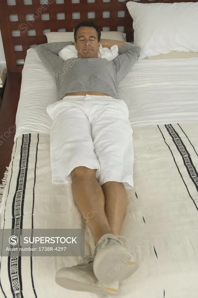 Man lying on a bed, indoors