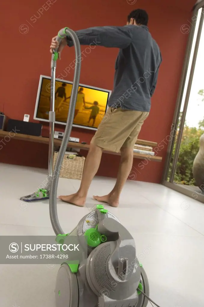 Man vacuuming, indoors