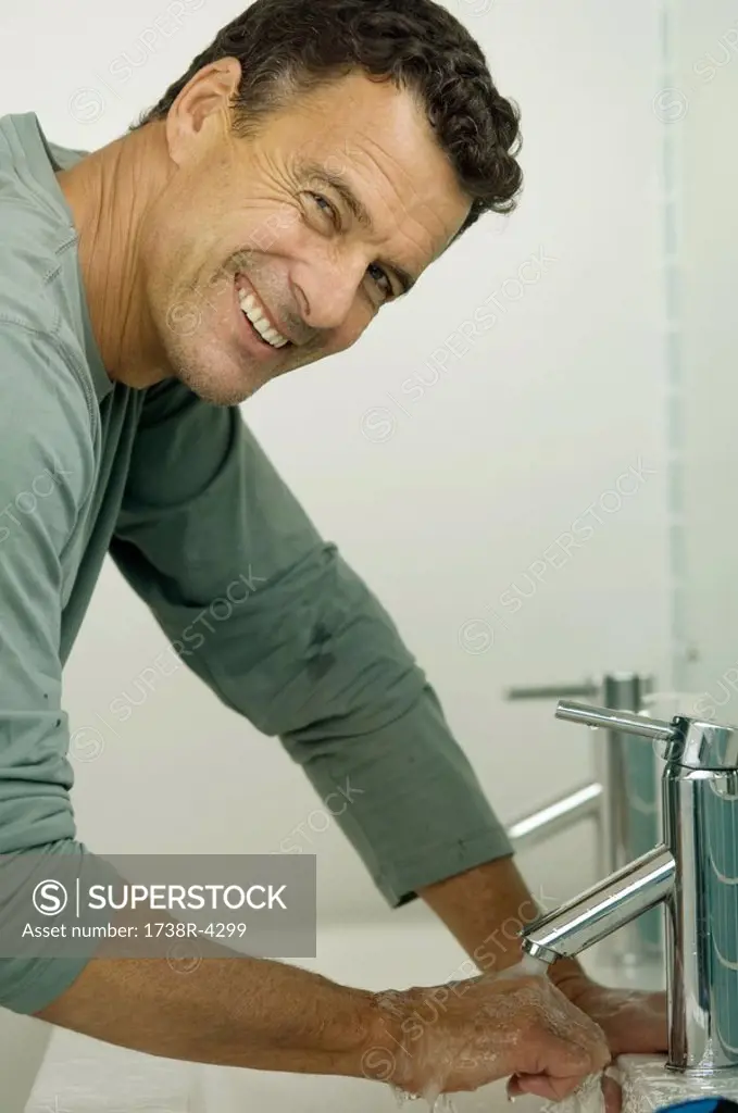 Man washing his hands, indoors