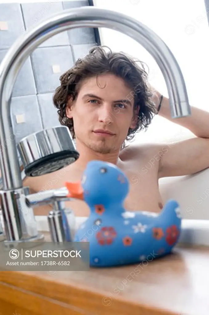 Man having a bath, looking at the camera