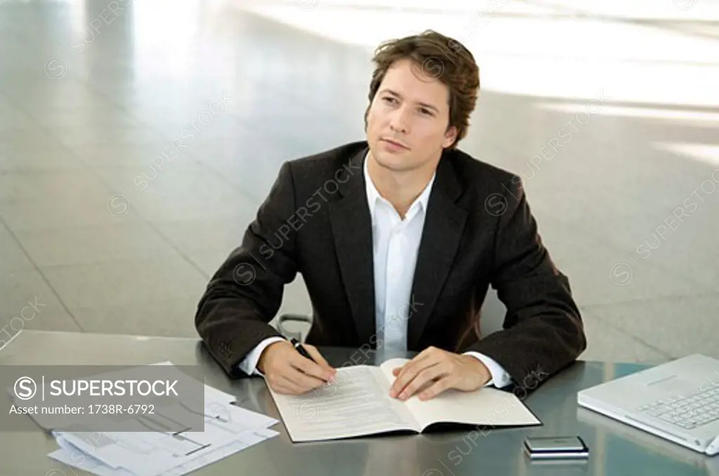 Businessman sitting at a desk and thinking