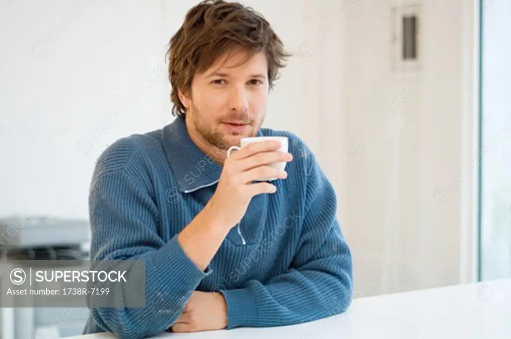 Portrait of a mid adult man holding a cup of tea
