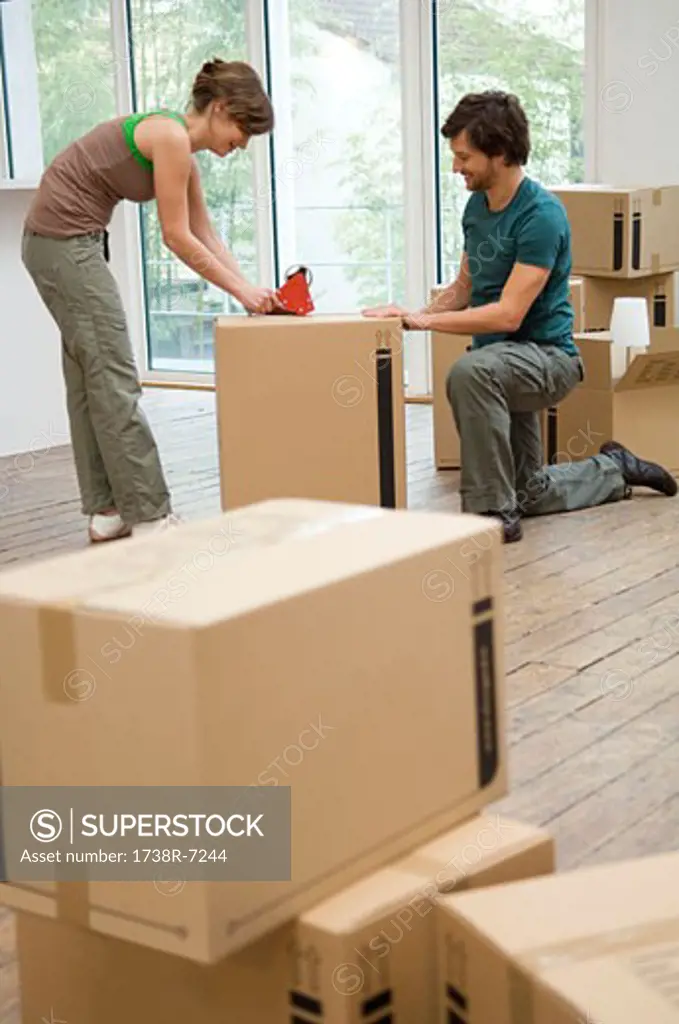 Couple packing cardboard boxes