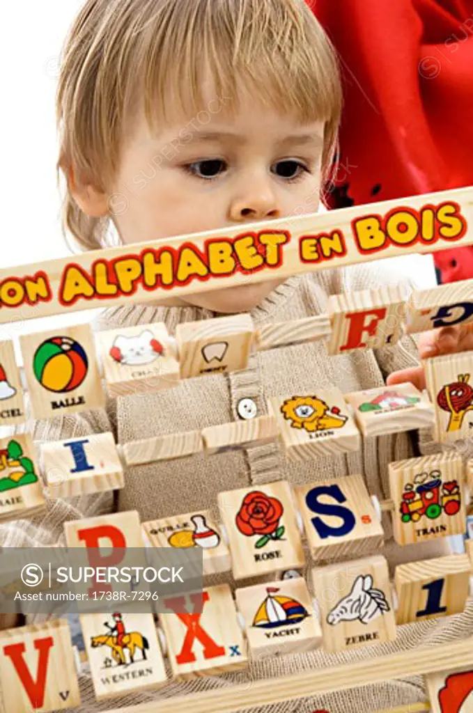 Close-up of a baby boy playing with alphabet blocks