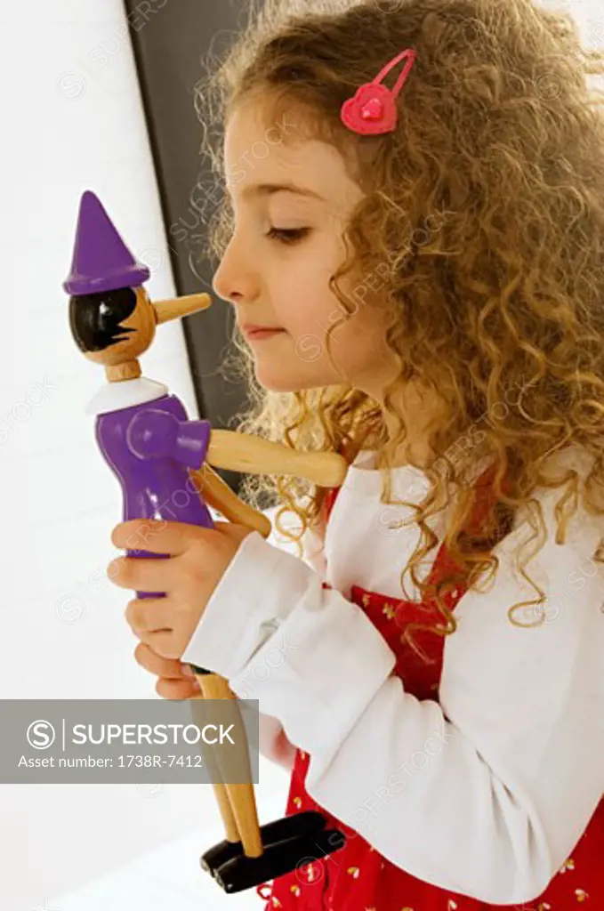 Side profile of a girl playing with a toy