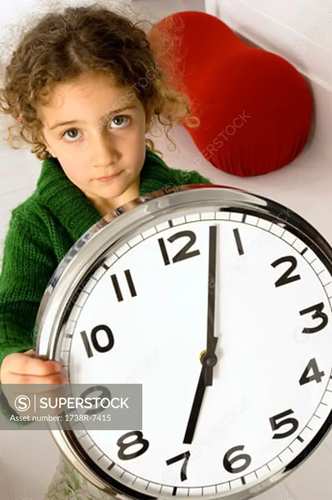 Portrait of a girl holding a clock