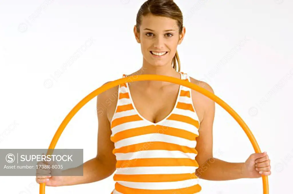 Portrait of a young woman holding a plastic hoop