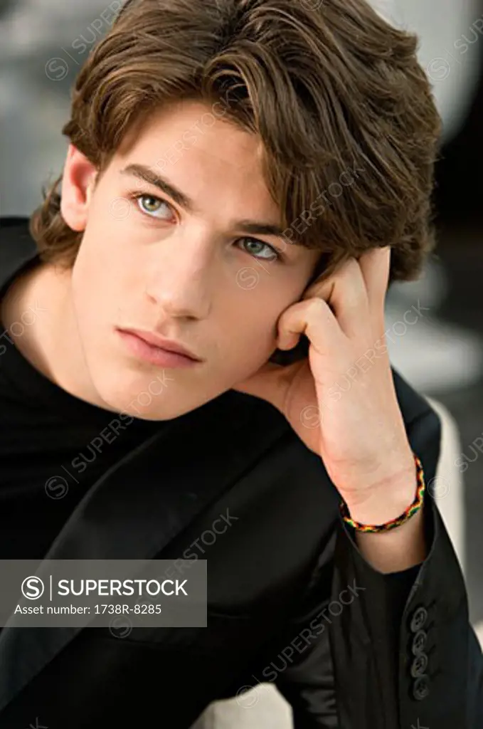 Close-up of a teenage boy looking up and thinking