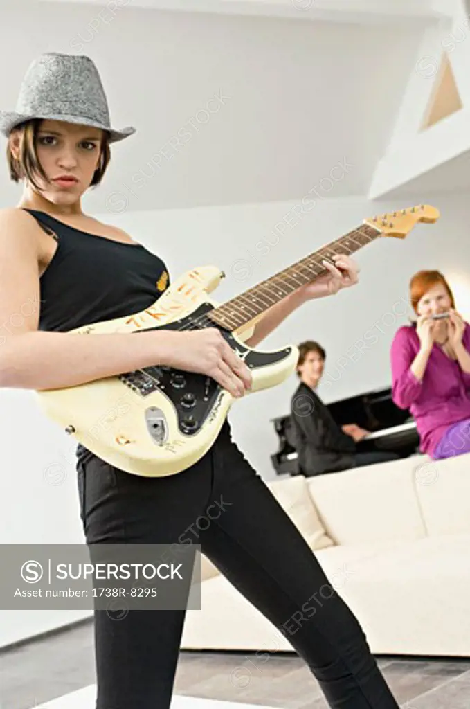 Portrait of a young woman playing a guitar
