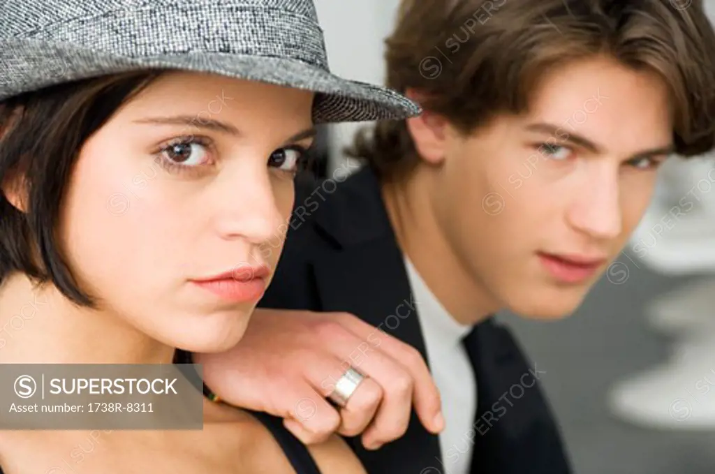 Portrait of a young woman and a teenage boy looking serious