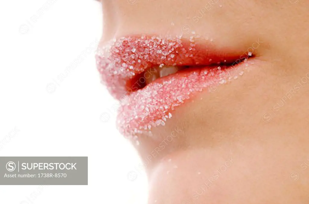 Close-up of a woman's lips covered with sugar