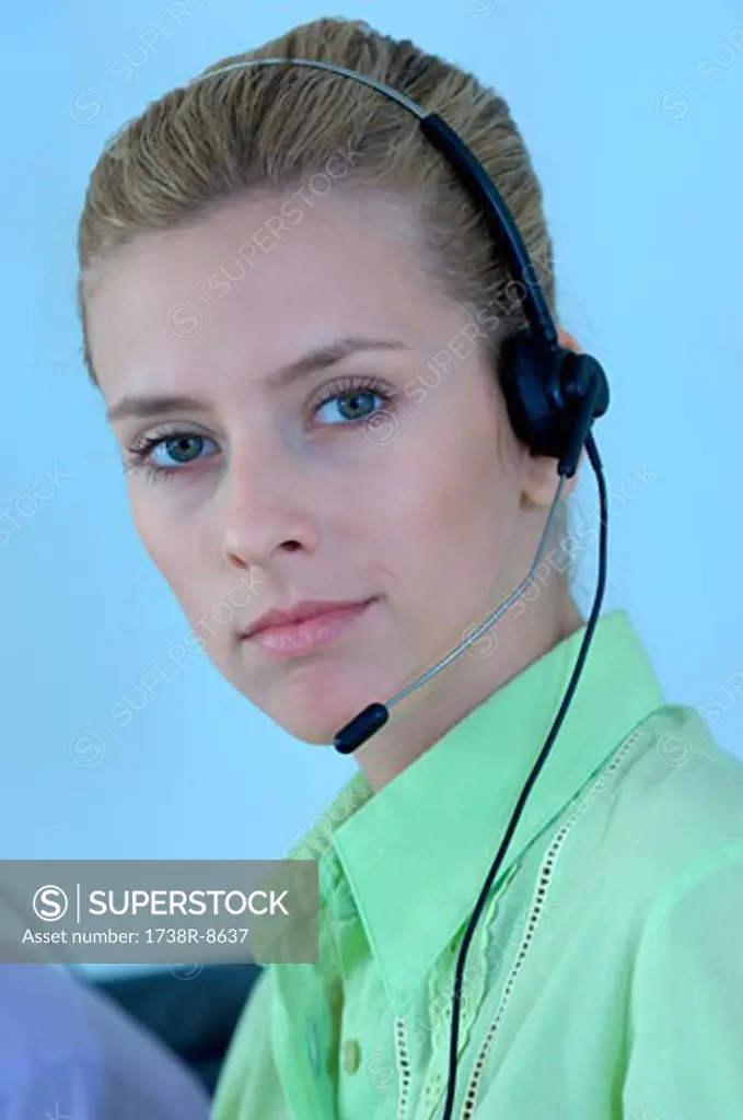 Young businesswoman wearing headset, portrait
