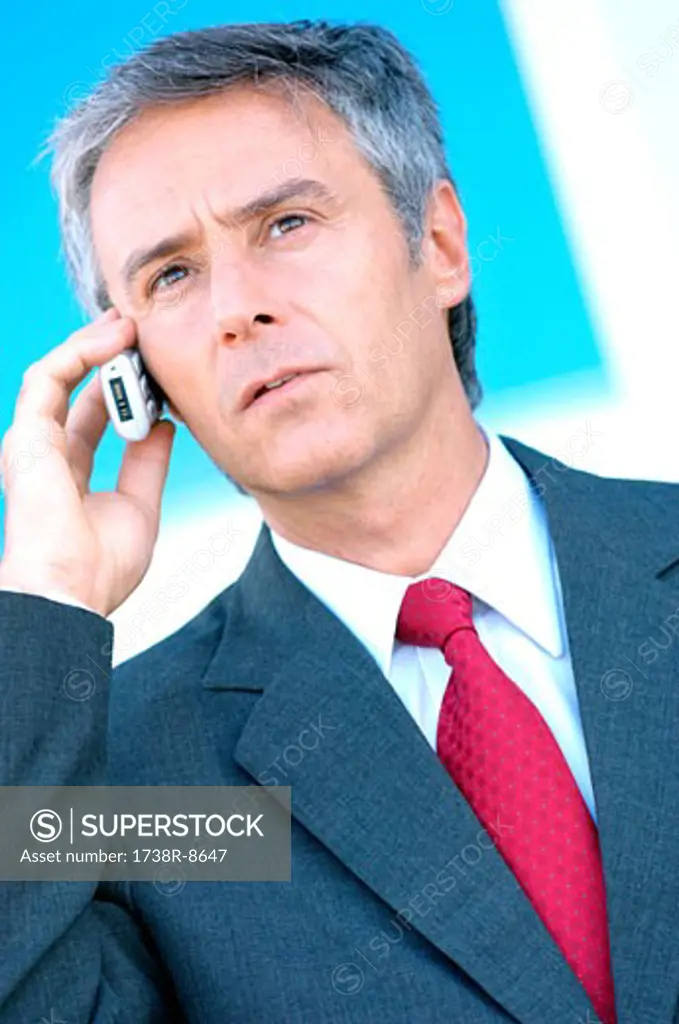 Mature businessman using mobile phone, close-up