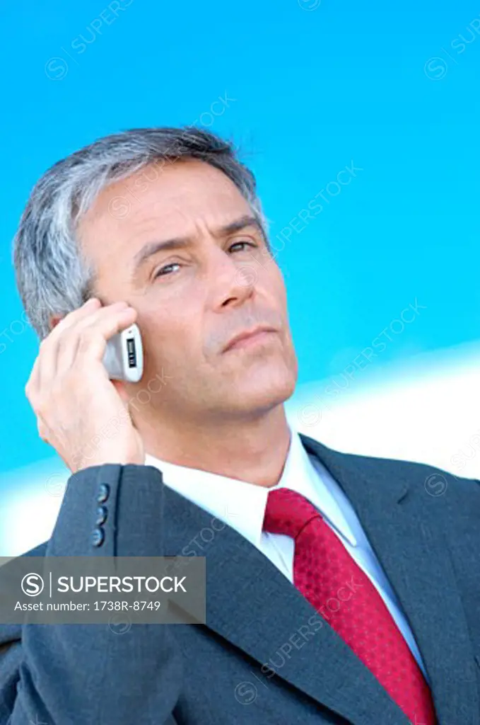 Mature businessman using mobile phone, portrait