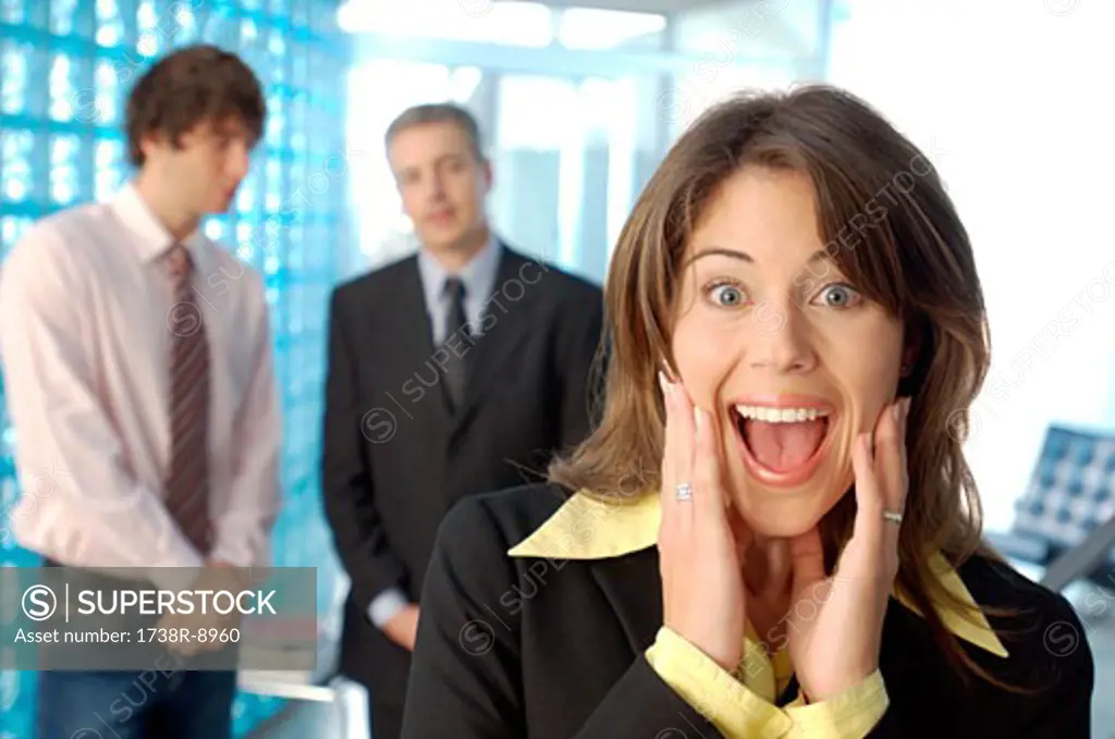 Businesswoman screaming with colleagues in background