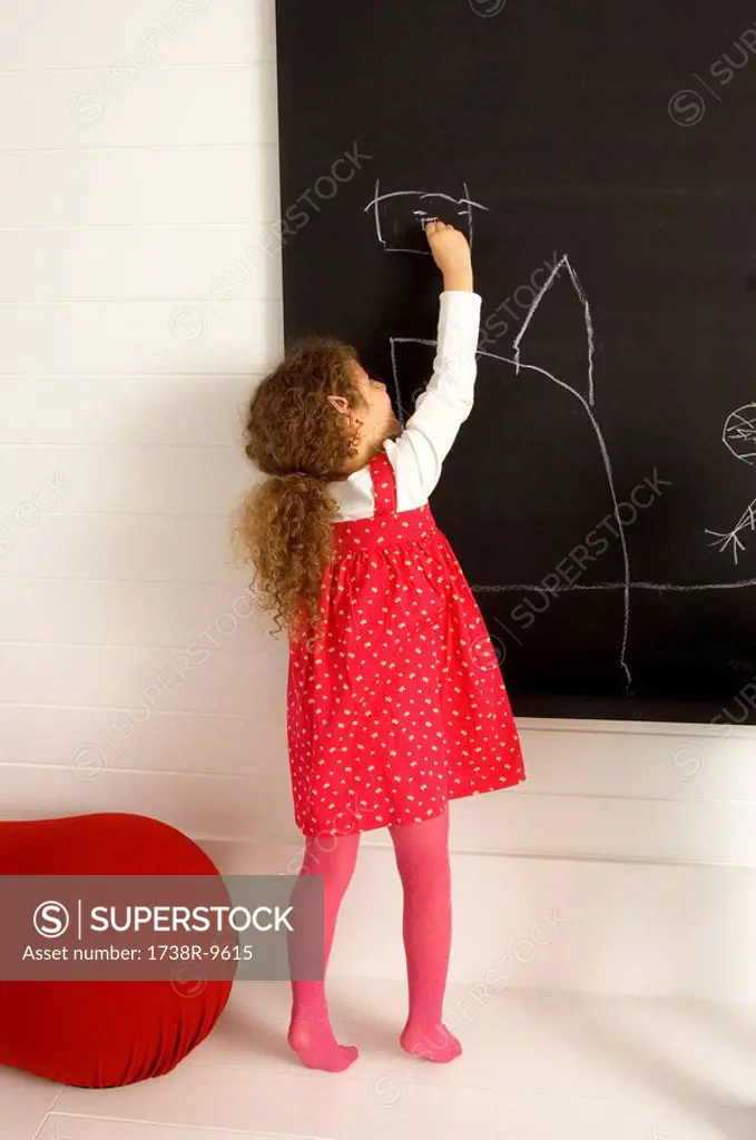 Girl drawing on a blackboard