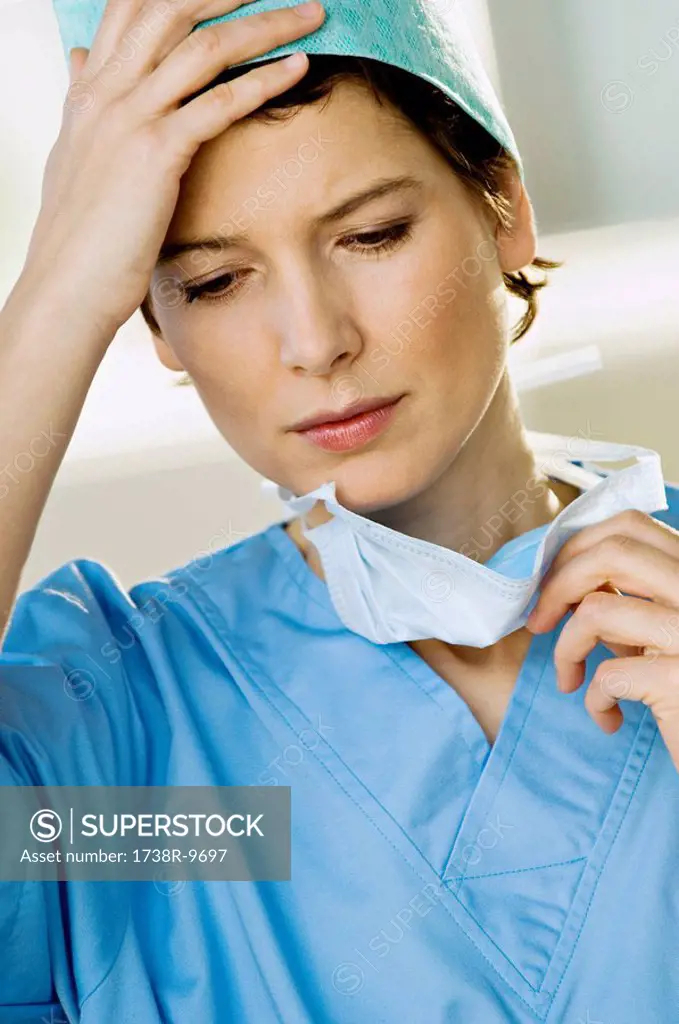 Close_up of a female doctor looking stressed
