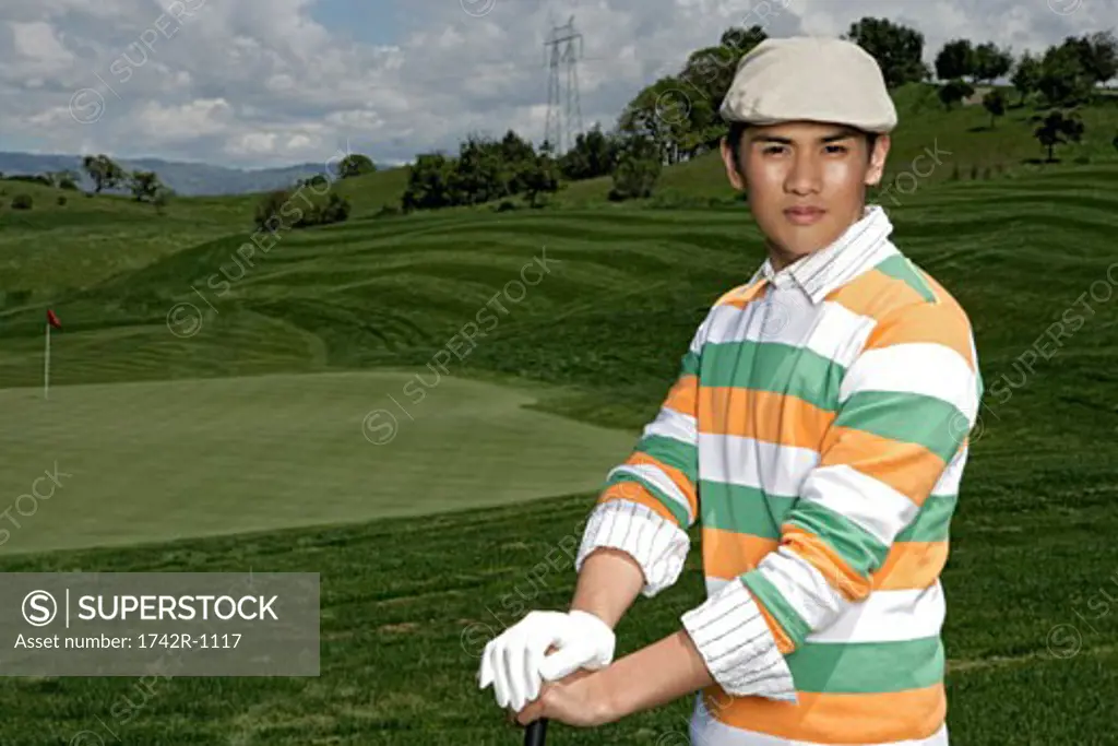 Portrait of a young man posing during a golf game.