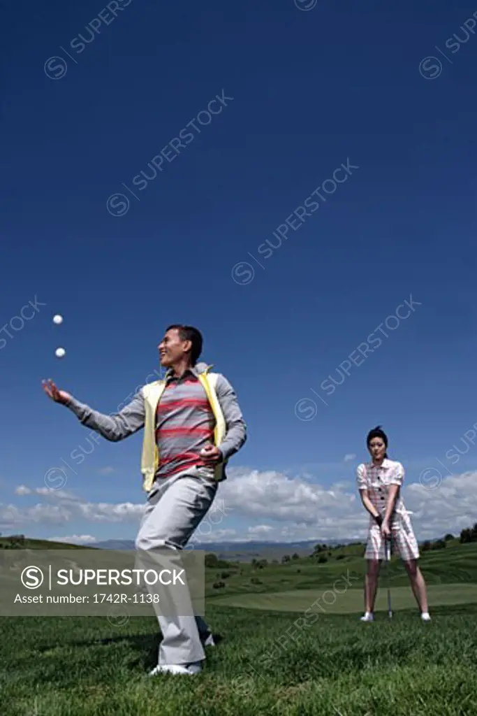 View of a couple in a golf course.