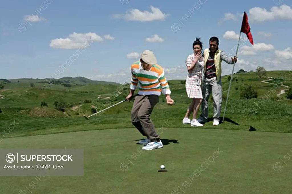 View of people rejoicing on a golf course.