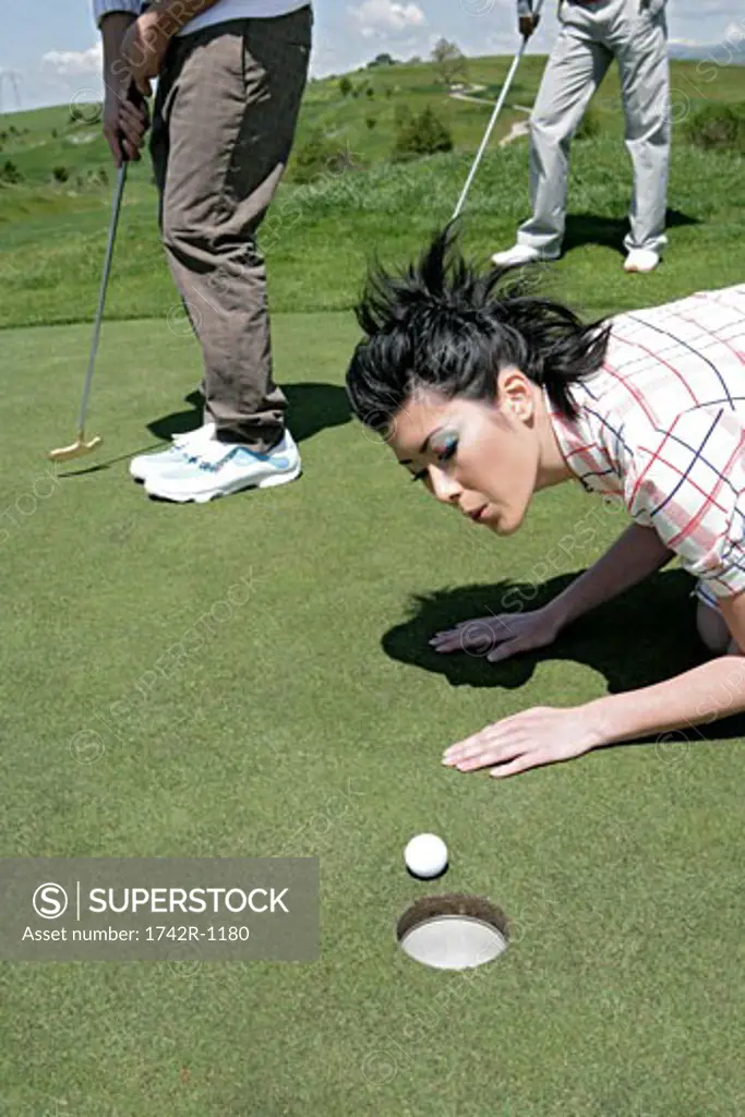 Young woman looking at a golf ball