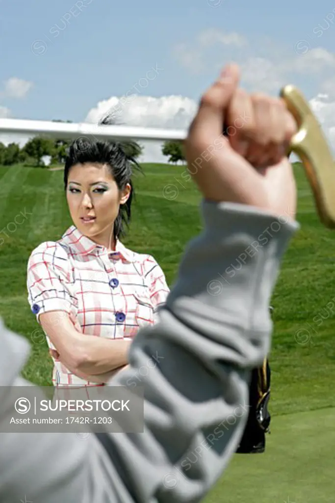 View of  a young woman, person holding a golf club