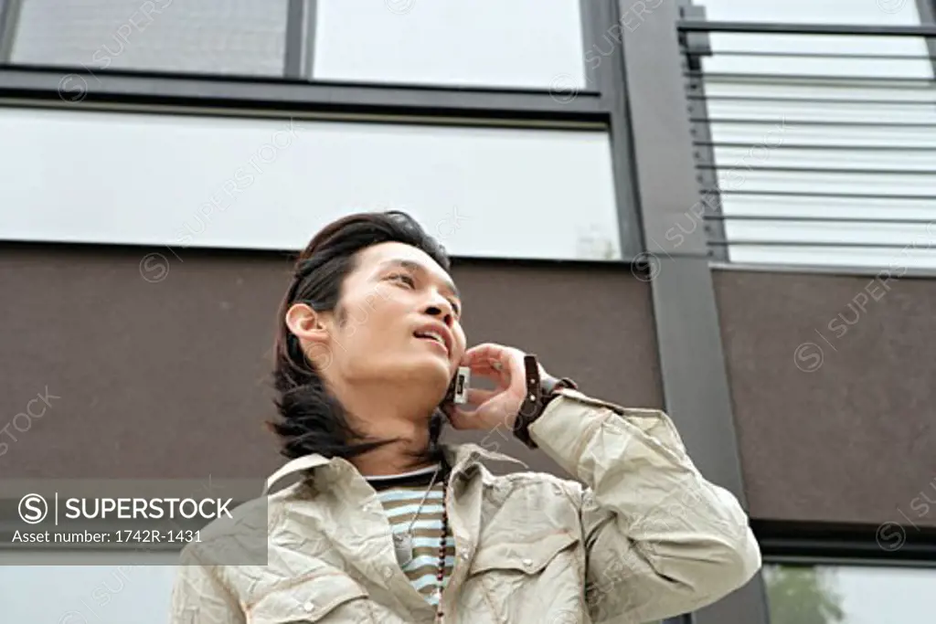 Young man talking on cell phone, portrait